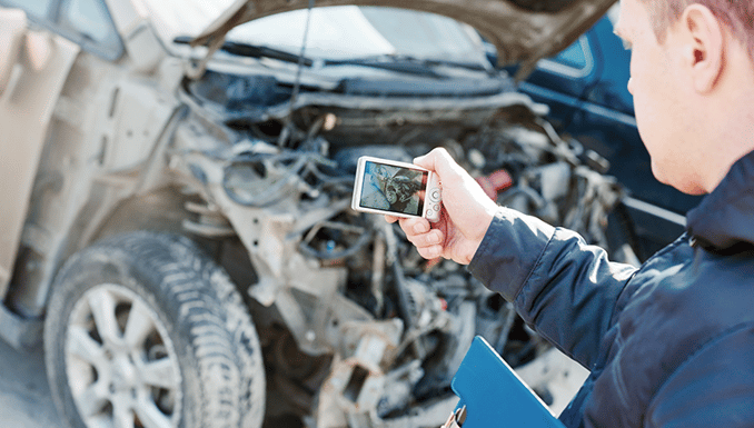 Insurance Agent Photographing Damage For Drunk Driver Auto Accident Claim