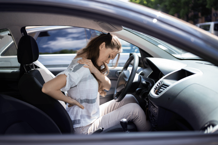 woman stretching her neck after a car accident neck injury