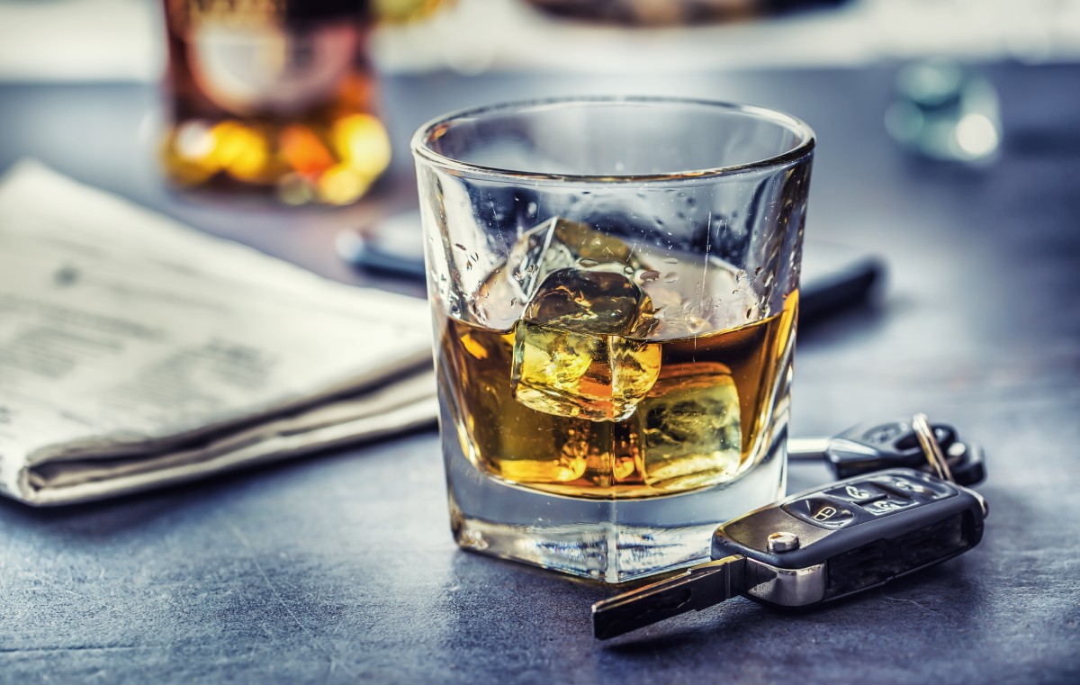 a bar top with two glasses of whiskey, and a set of car keys