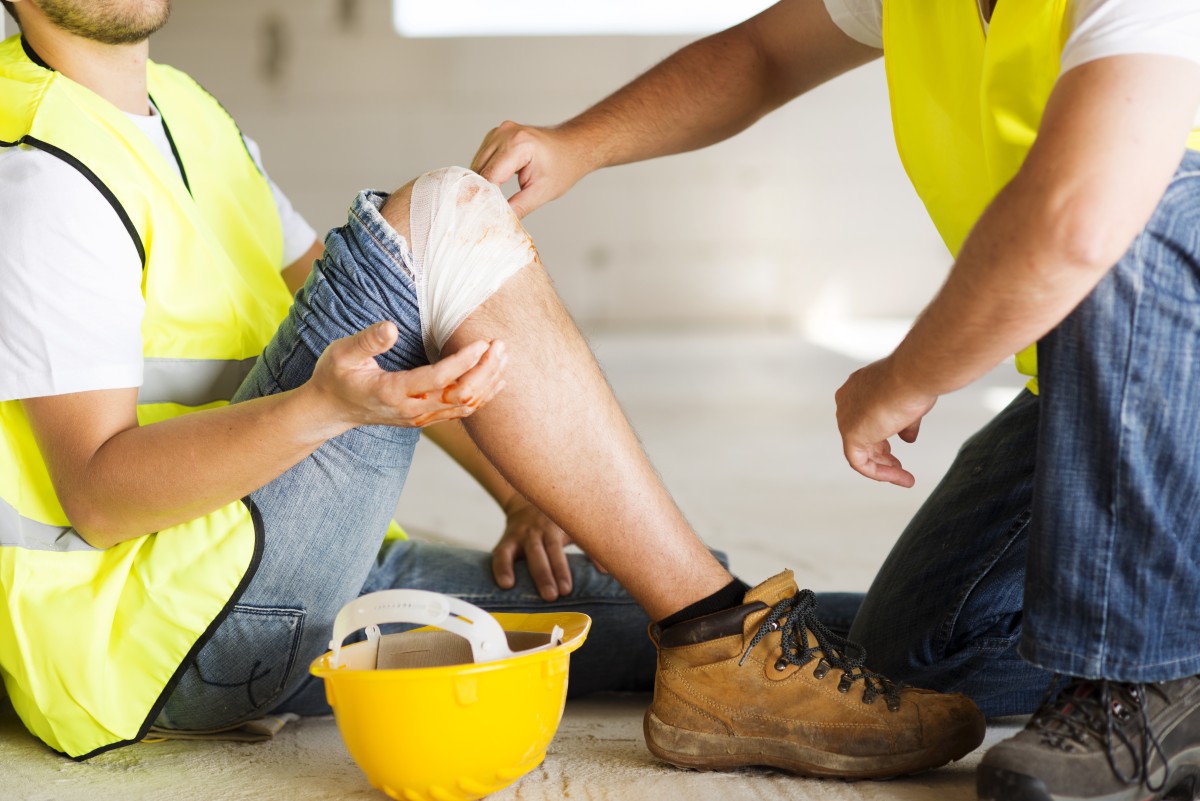 a worker bandaging his coworker after an on site injury