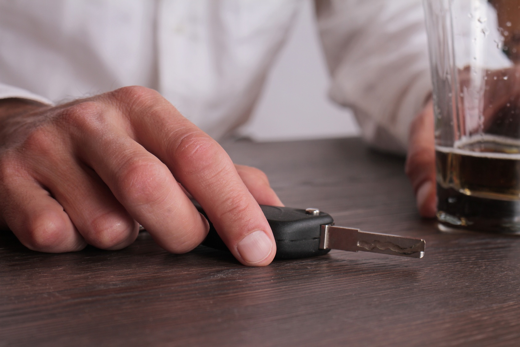 DUI_Accident_in_Hernando_County a man with a beer in one hand, and his car keys in the other
