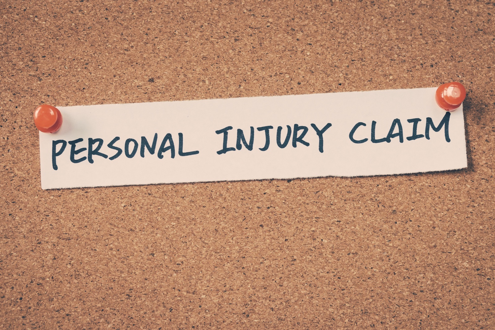 Is_PIP_Insurance_Required_on_My_Policy_in_Florida A piece of paper thumbtacked to a board that reads "personal injury claim"