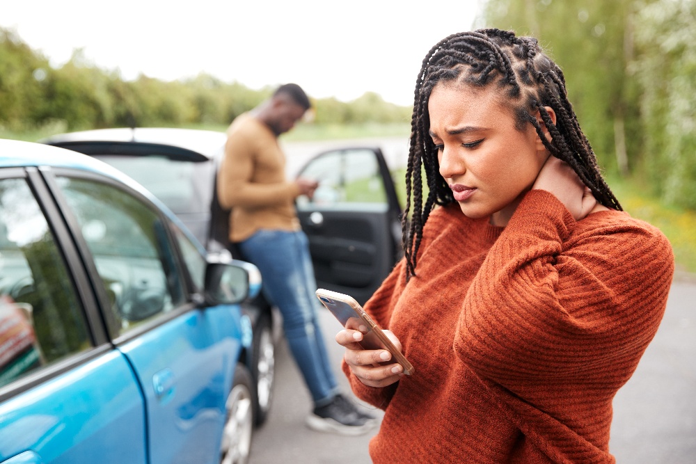 LOW%20Acci-1 A woman holding her neck after a car accident