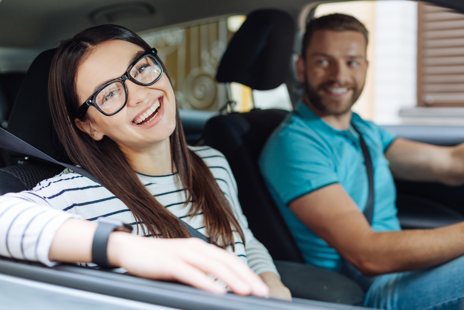 Two people enjoying a nice car ride
