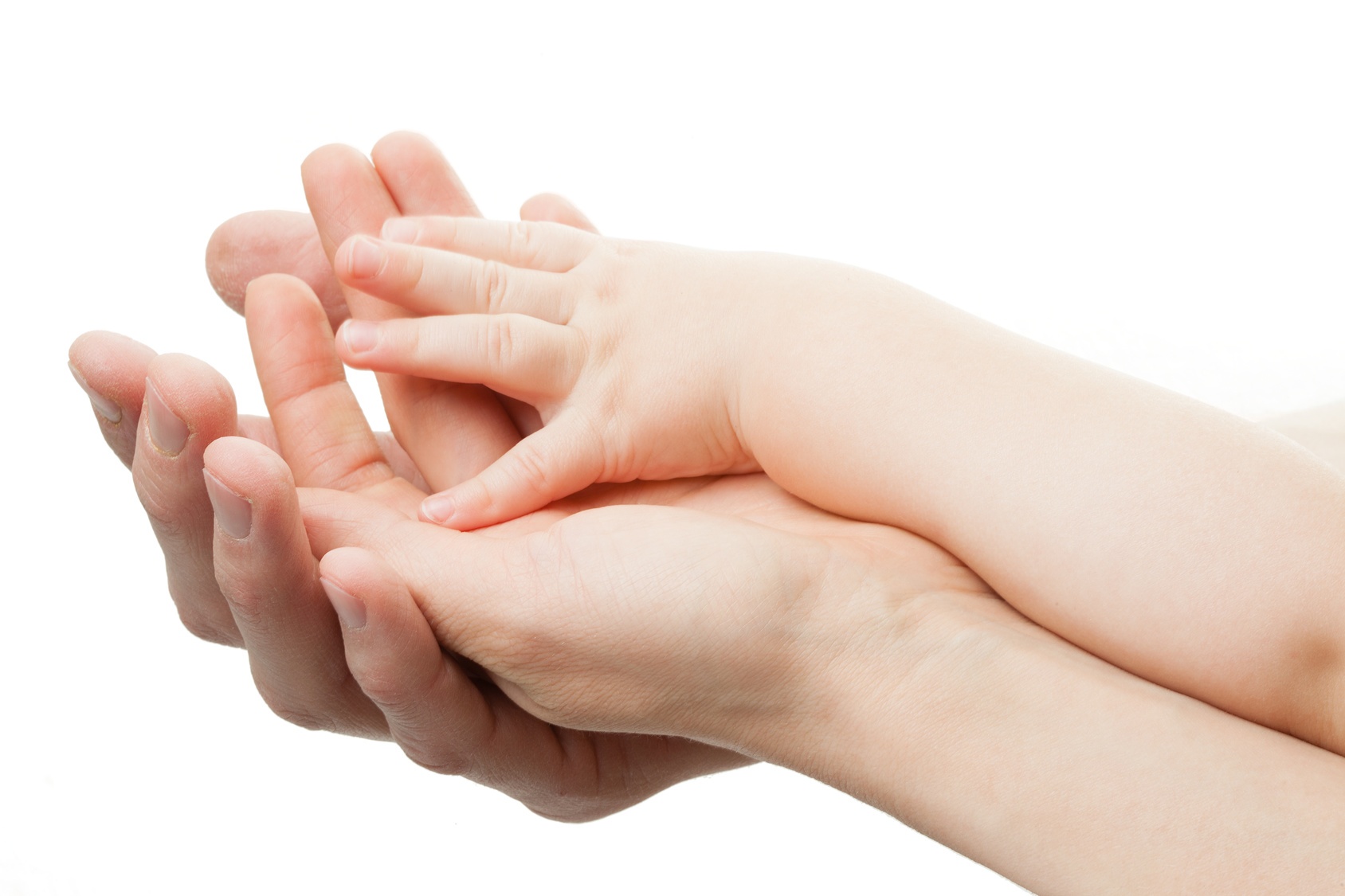 An adult holding a baby's hand