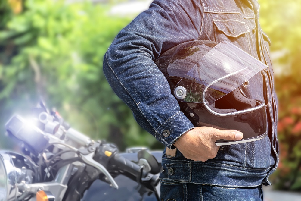 Person holding motorcycle helmet