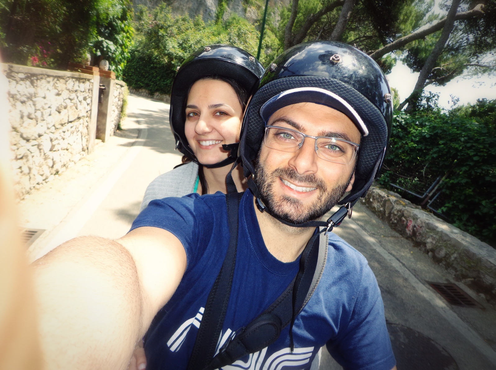 a couple taking a selfie while driving a motorcycle