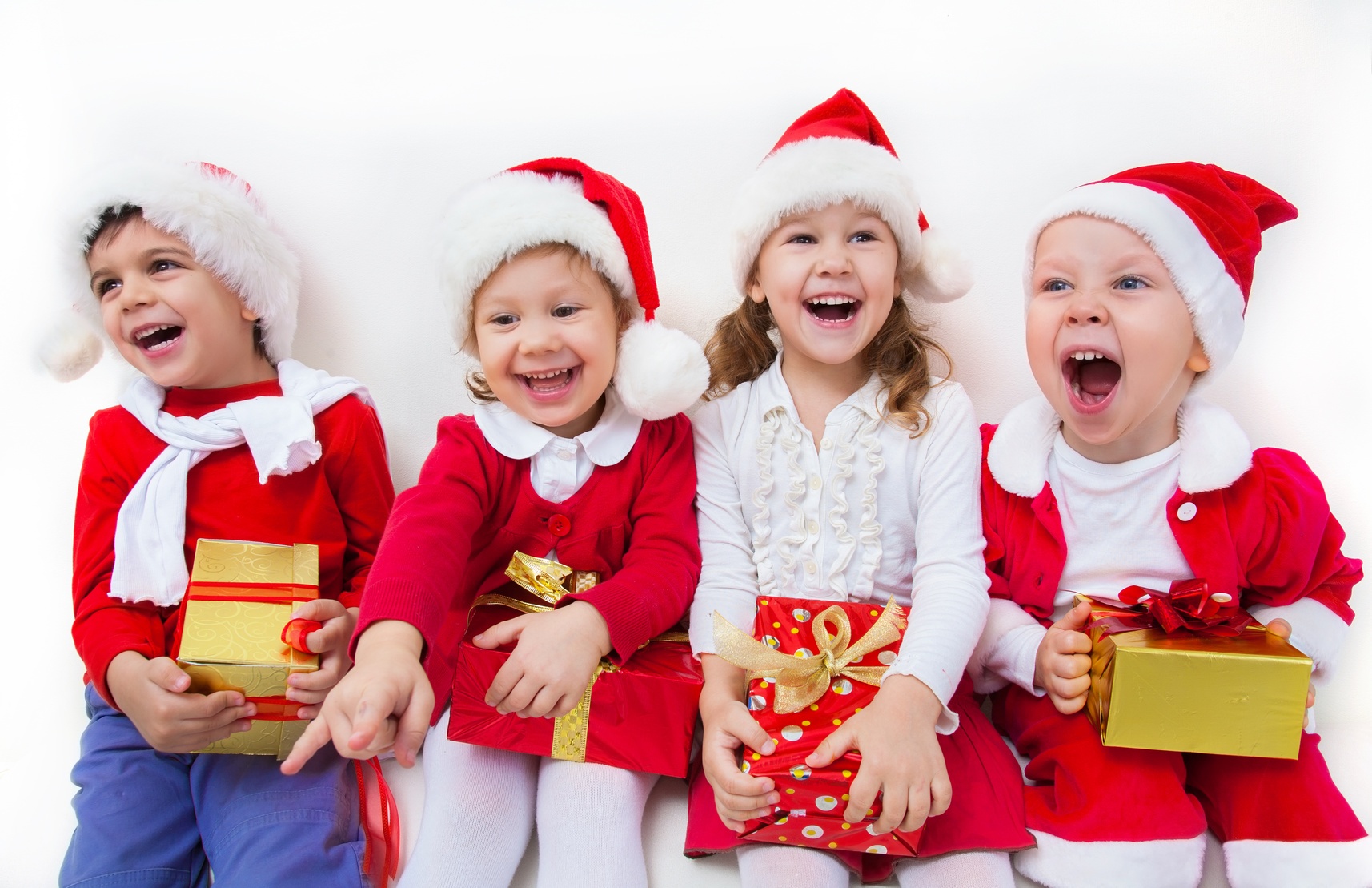 Shiloh_New_Beginning_Support four small children in Christmas clothes holding gifts and screaming as loud as they can