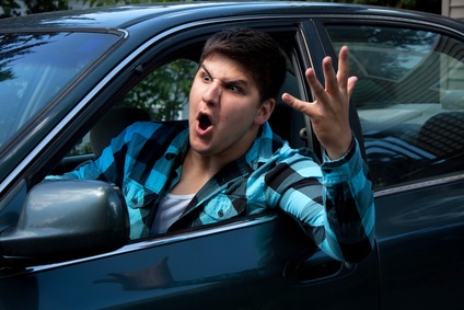 Spring_Hill_Aggressive_Driving_Car_Accidents A man yelling out of his driver side window at someone.