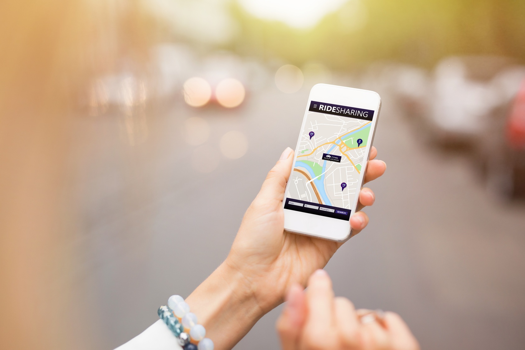 Uber_and_Lyft Someone using their phone to hail a rideshare