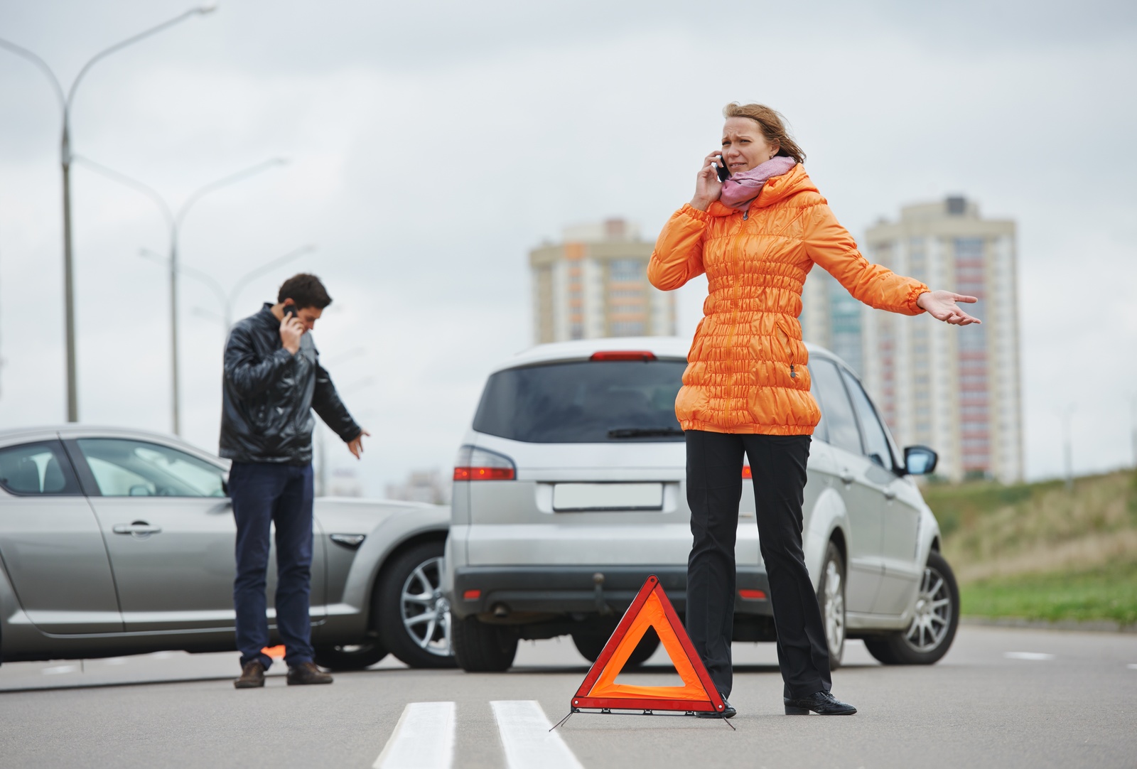 What%20to%20know%20if%20you%20have%20been%20in%20an%20auto%20accident A woman and a man on the phone after being involved in a car accident with each other