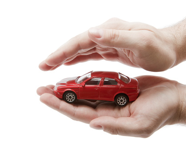 Car protection. Clipping path included. A toy car being protected in the palm of someone's hands