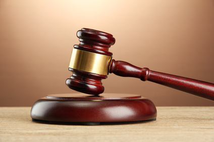 wooden gavel on wooden table, on brown background wooden gavel on wooden table, on brown background