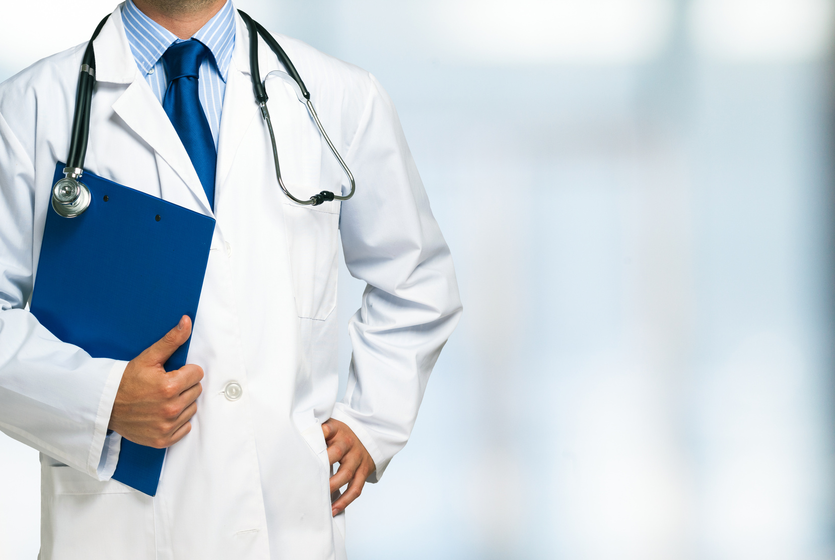 Doctor holding a clipboard Detail of a doctor holding a clipboard