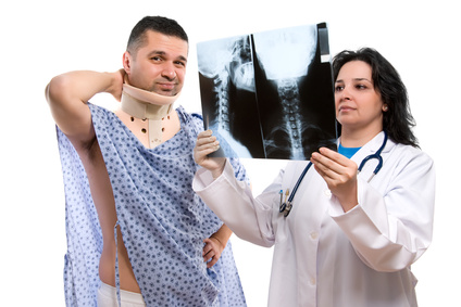 Caucasian female doctor looking at neck x-ray isolated on white Caucasian female doctor looking at neck x-ray isolated on white