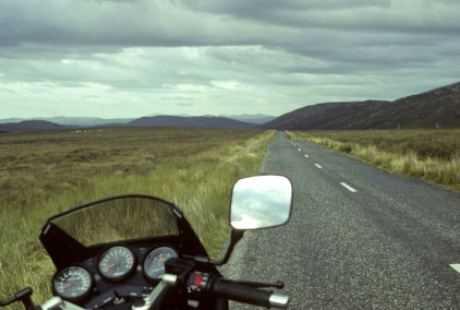landscape with menacing sky, motorcycle on empty irish road