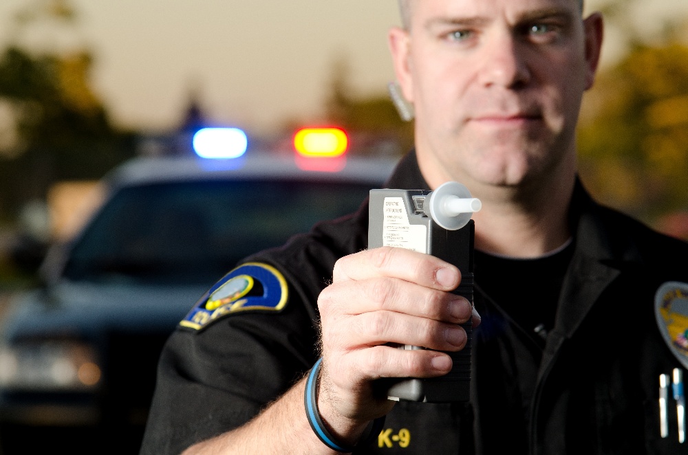 low%20dui-1 A cop administering a breathalyzer test