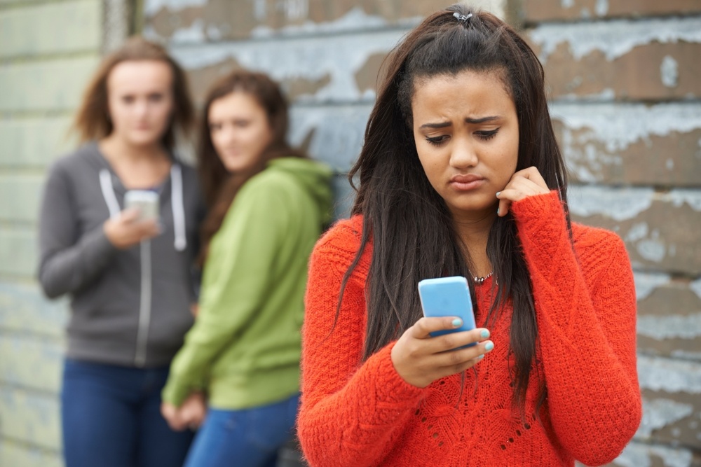 lowman%20cyberbully-594858-edited A teenager reading a mean text.