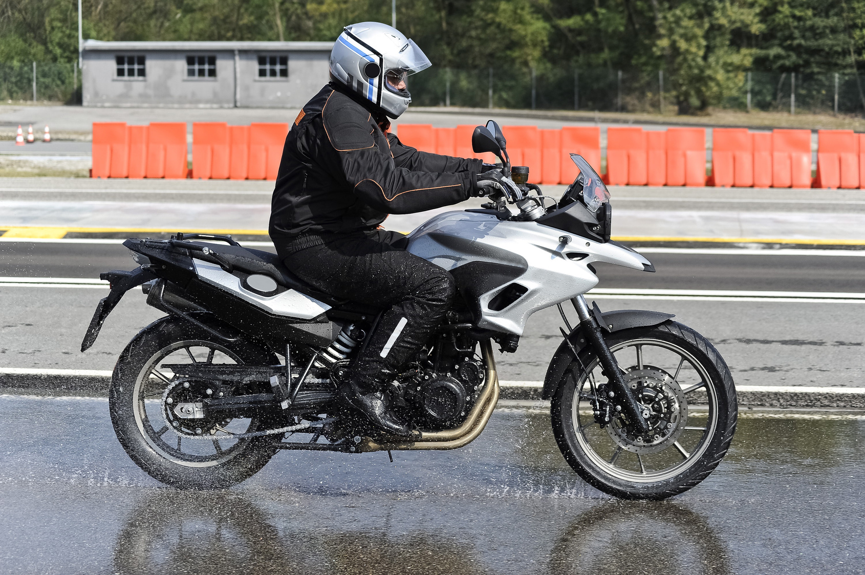 biker on road biker on road with helmet and wet asphalt