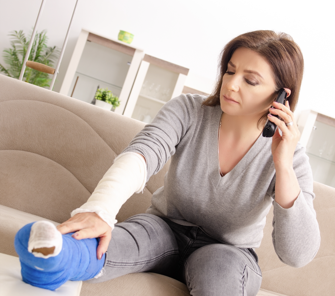 recovering from leg injury woman with an injured leg on the phone