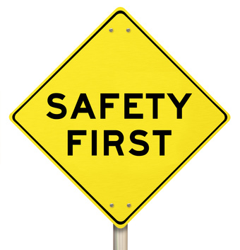 Yellow Warning Sign – Safety First – Isolated A yellow diamond-shaped road sign cautions Safety First