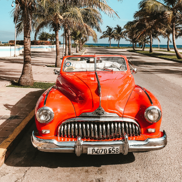 Vintage Orange Car on a Florida Street with Palm Trees